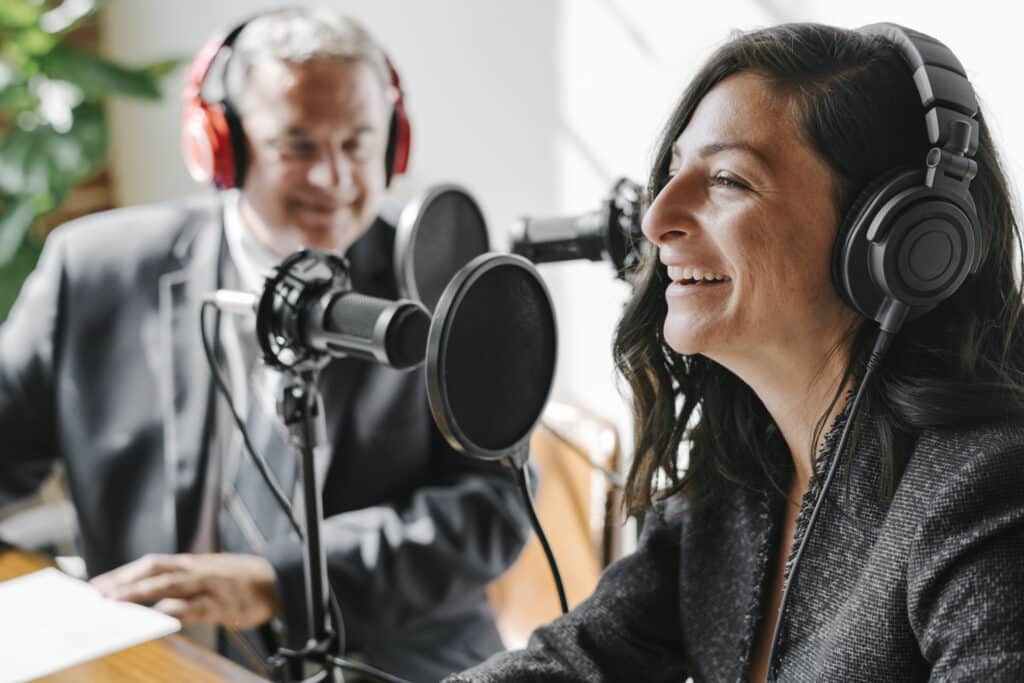 Female broadcaster interviewing her guest in a studio